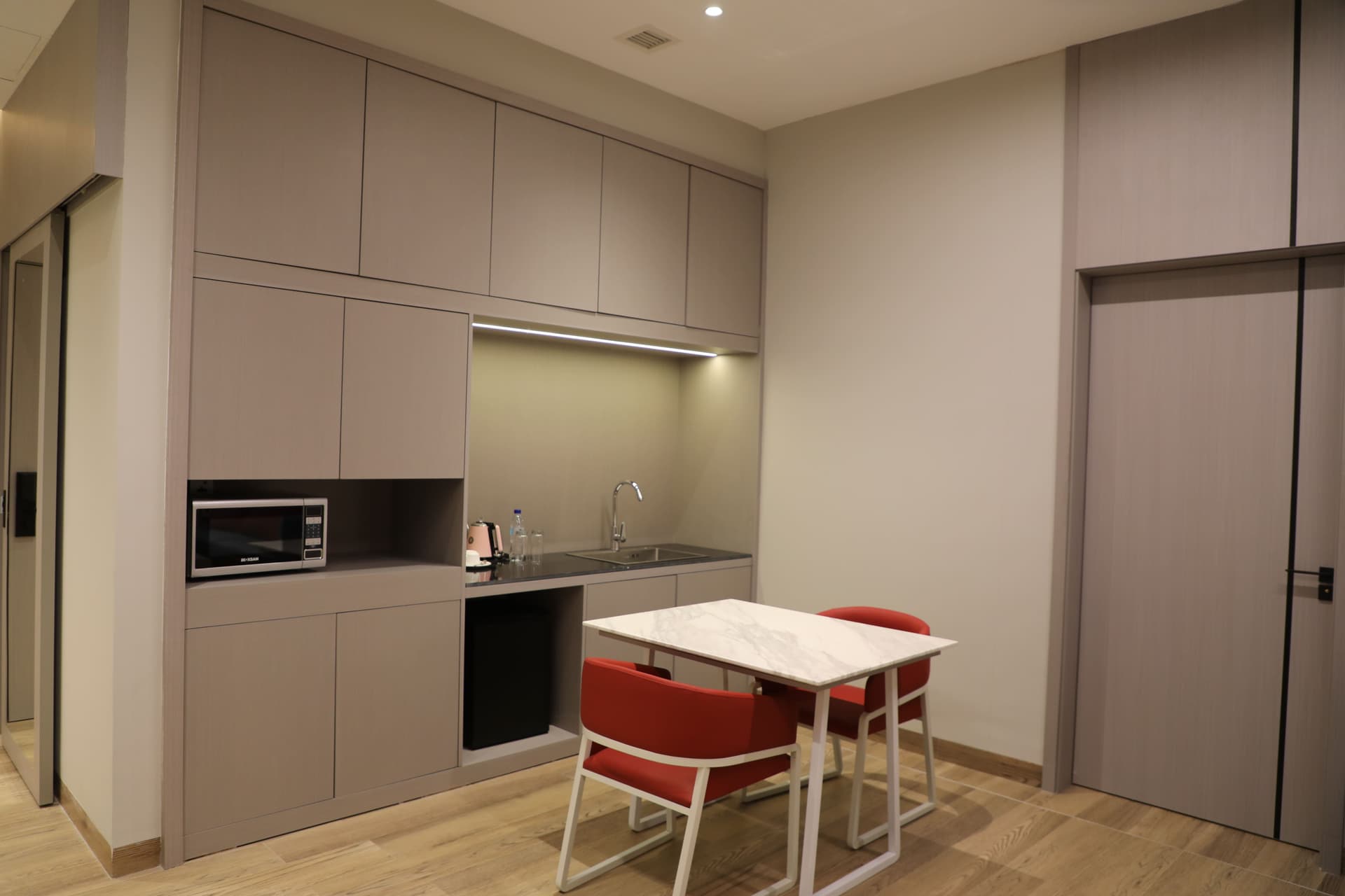 Kitchenette with cabinetry and under-counter refrigerator